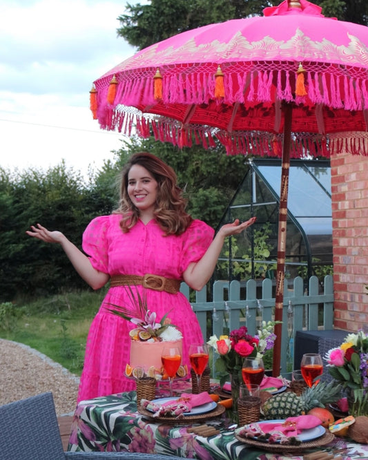 pink bali parasol with orange tassels