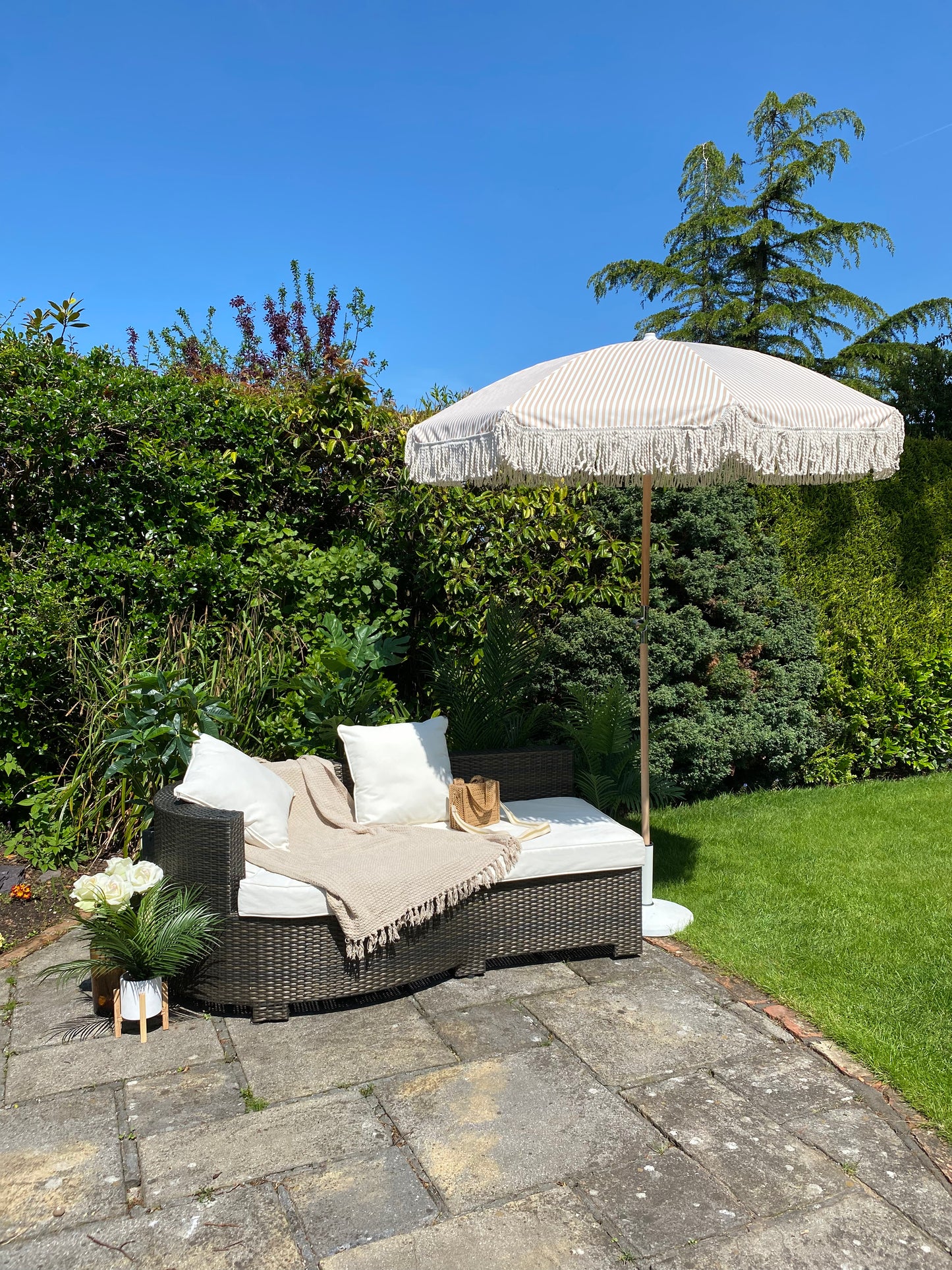 white and beige parasol with fringe