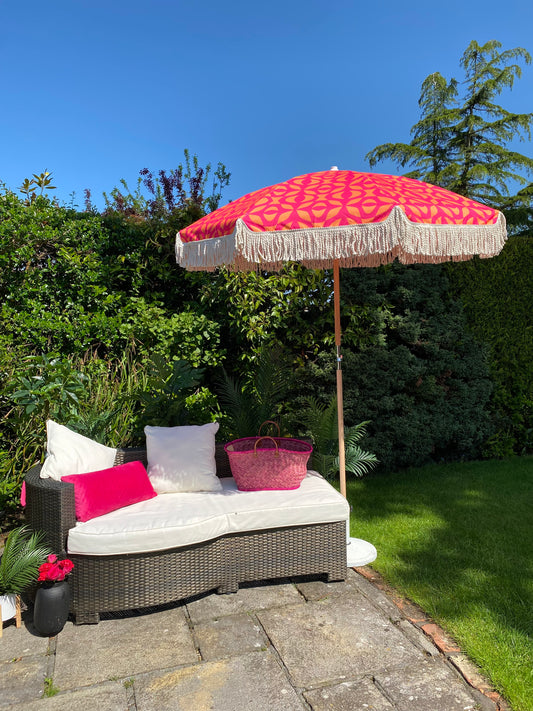 bright pink and orange on trend geometric print parasol with fringe