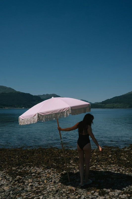 pink and white striped parasol umbrella