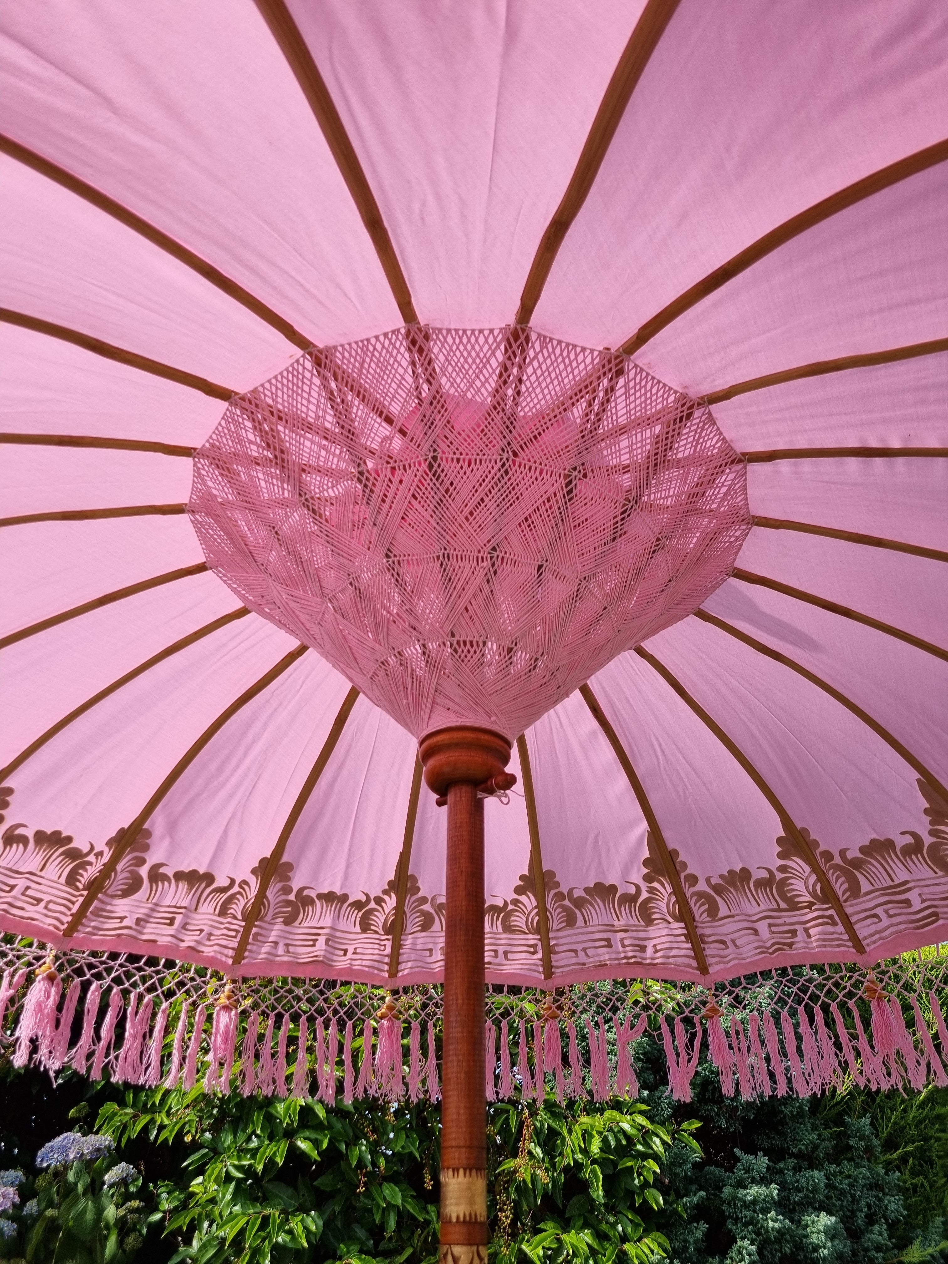 The Aurelia Pastel Pink Bali Garden Parasol With Pink Tassel Details on Umbrella Canopy